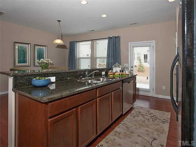 220 Leighann Ridge Lane Rolesville, NC 27571 - Photo 1 of 23 a kitchen with granite countertop a sink and a wooden floor