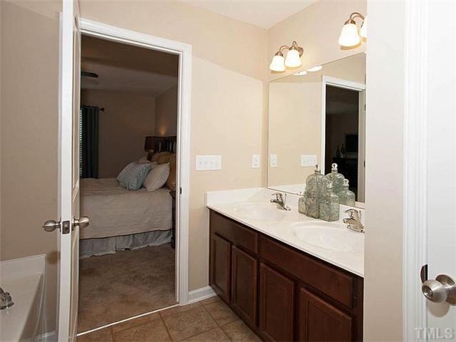 220 Leighann Ridge Lane Rolesville, NC 27571 - Photo 14 of 23 a en suite bathroom with a granite countertop sink and mirror