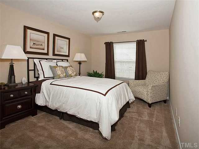 220 Leighann Ridge Lane Rolesville, NC 27571 - Photo 9 of 23 a bedroom with a bed and a night stand
