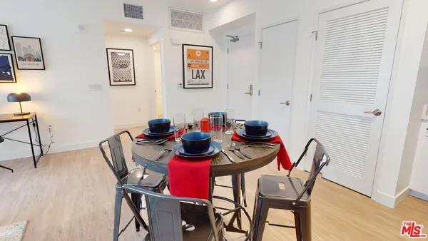 a view of a dining room with furniture and wooden floor