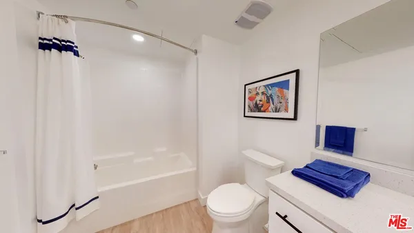 a bathroom with a toilet a sink and shower