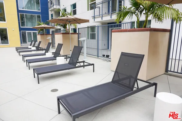 a view of a patio with a table and chairs