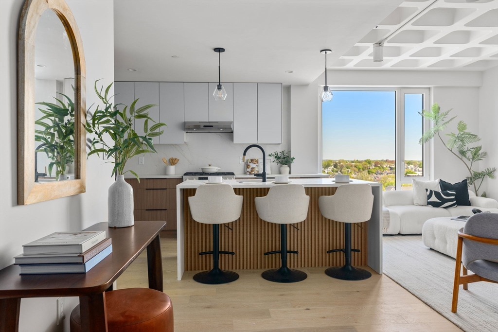 125 Lowell Street, Unit 503 Somerville, MA 02143 - Photo 11 of 17 a kitchen with a sink dining table and chairs