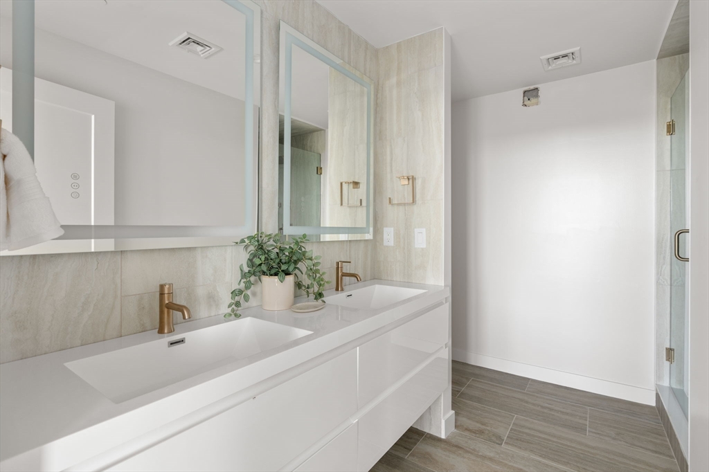 125 Lowell Street, Unit 503 Somerville, MA 02143 - Photo 3 of 17 a bathroom with a sink and a mirror