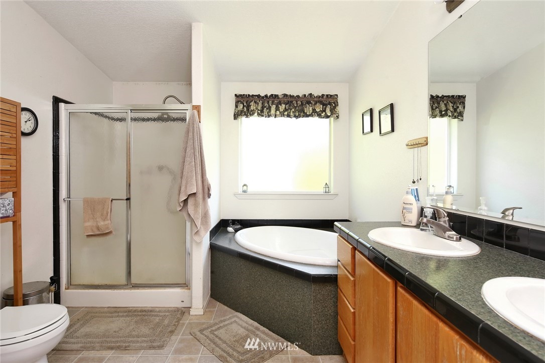 3125 Brown Road Ferndale, WA 98248 - Photo 13 of 24 a bathroom with a granite countertop sink mirror vanity and toilet