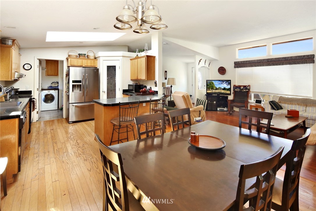 3125 Brown Road Ferndale, WA 98248 - Photo 7 of 24 a dining room with stainless steel appliances kitchen island granite countertop a table chairs and a living room view
