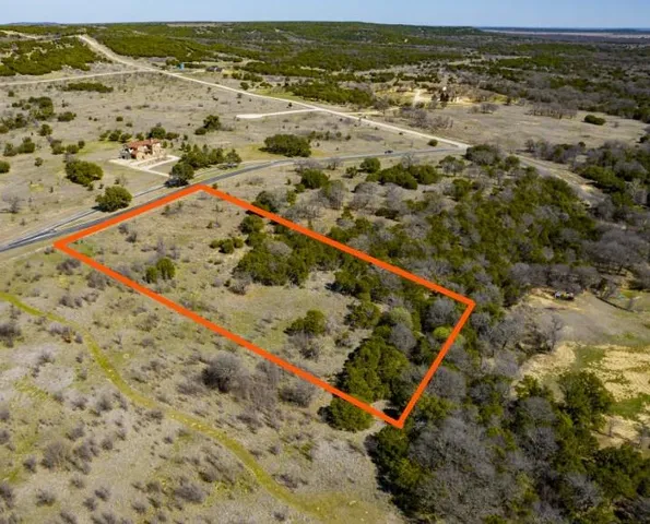 an aerial view of houses with a swimming pool