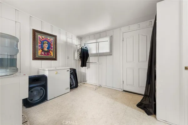 a view of a storage & utility room with a window