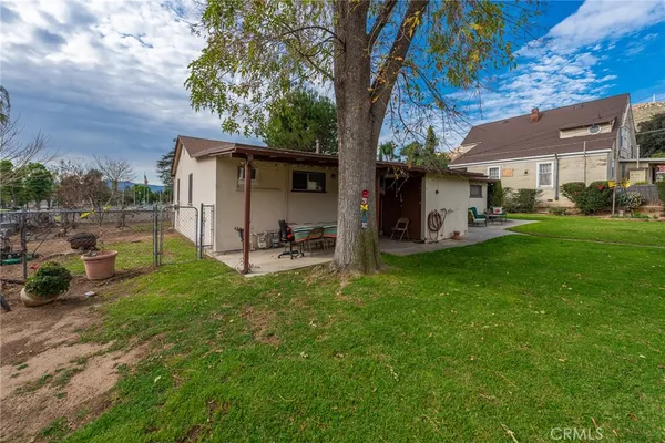 a view of a backyard with plants and a patio