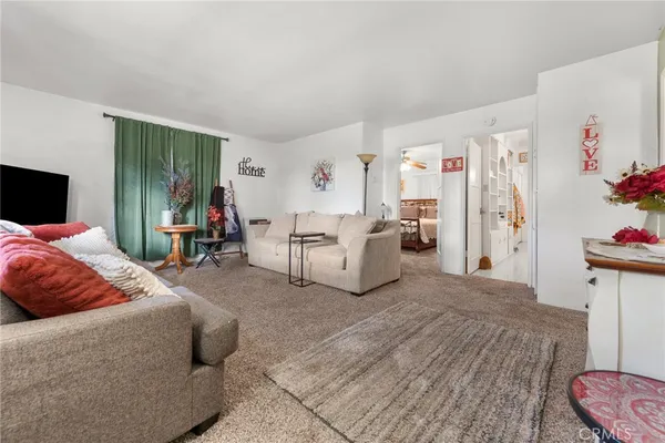 a bedroom with a large bed and a couch