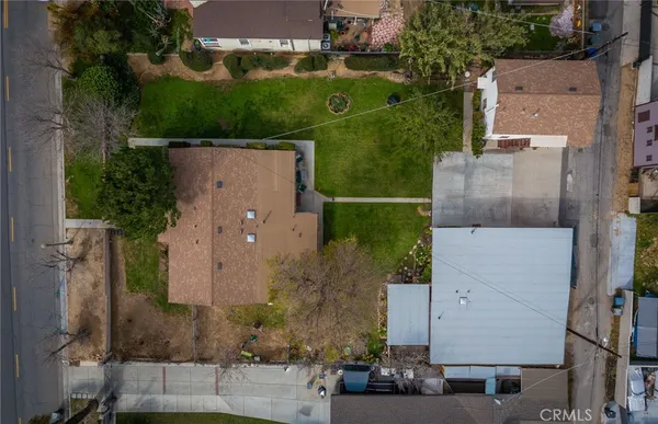 an aerial view of a house with a yard