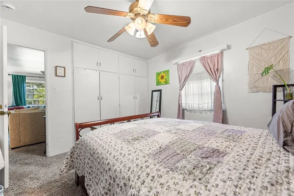 a bedroom with a large bed and a chandelier