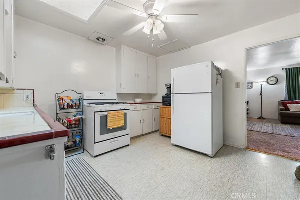 a kitchen with a refrigerator a stove and a stove
