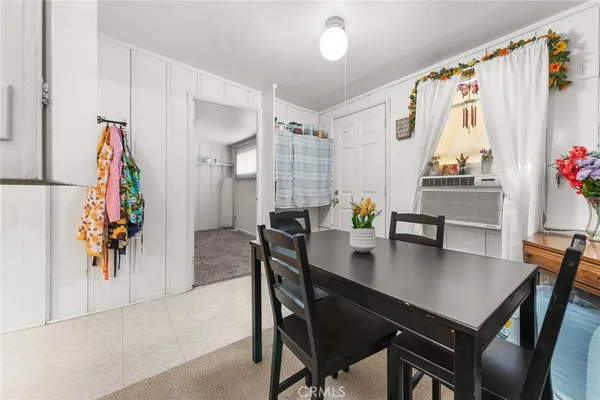 a view of a dining area with furniture and a chandelier