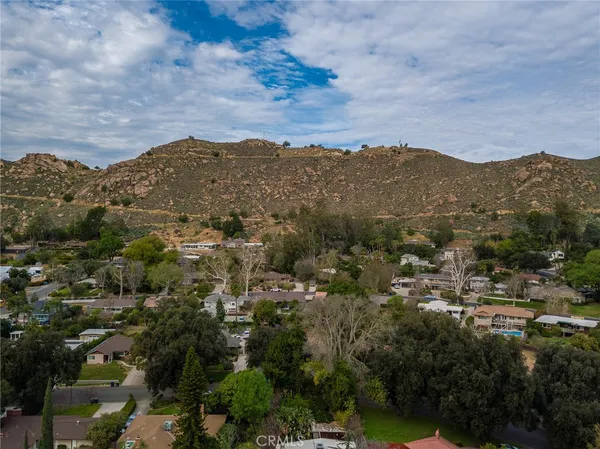 an aerial view of houses covered in trees