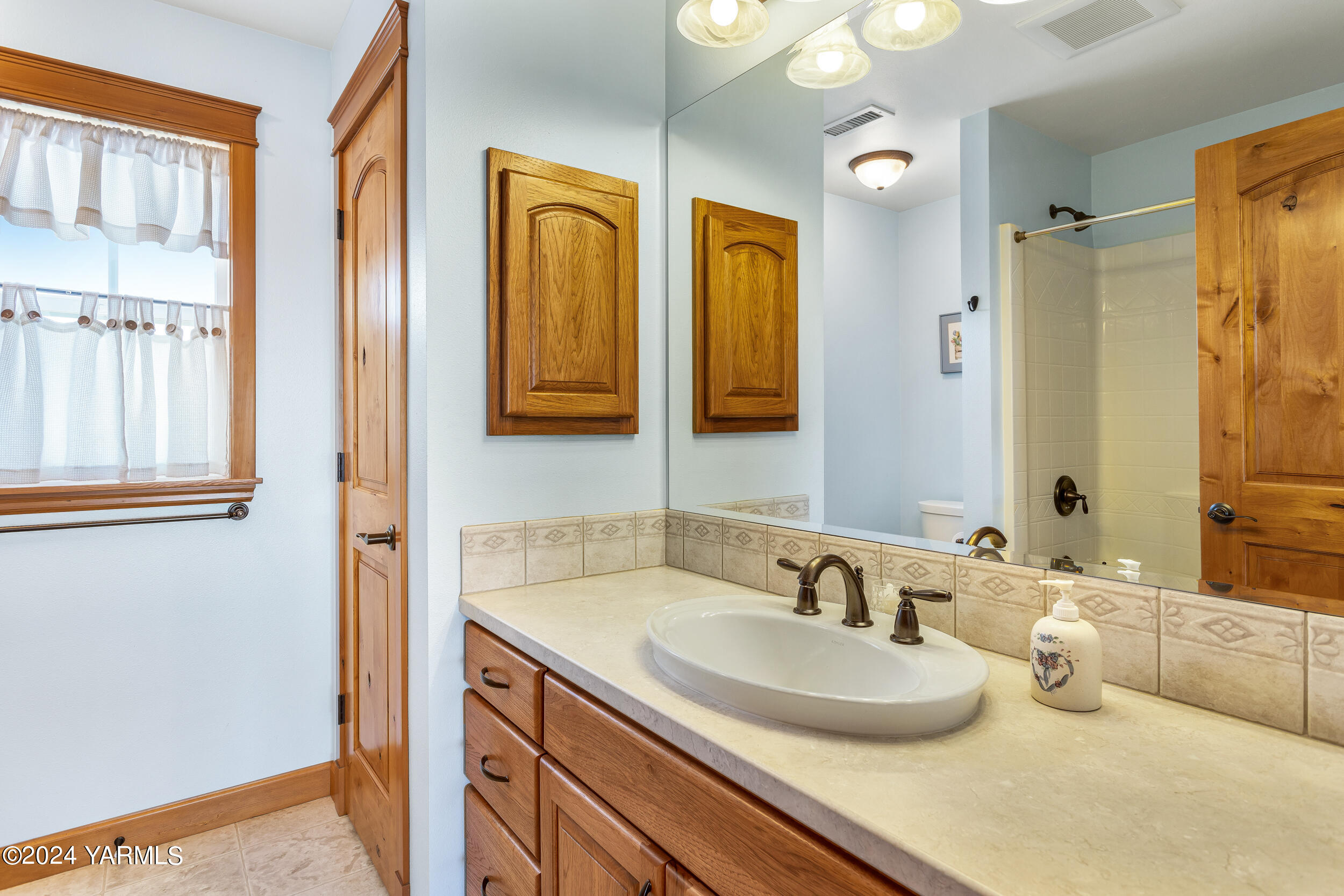 12401 Summitview Ext Road Yakima, WA 98908 - Photo 57 of 63 a bathroom with double vanity sinks a mirror and a shower