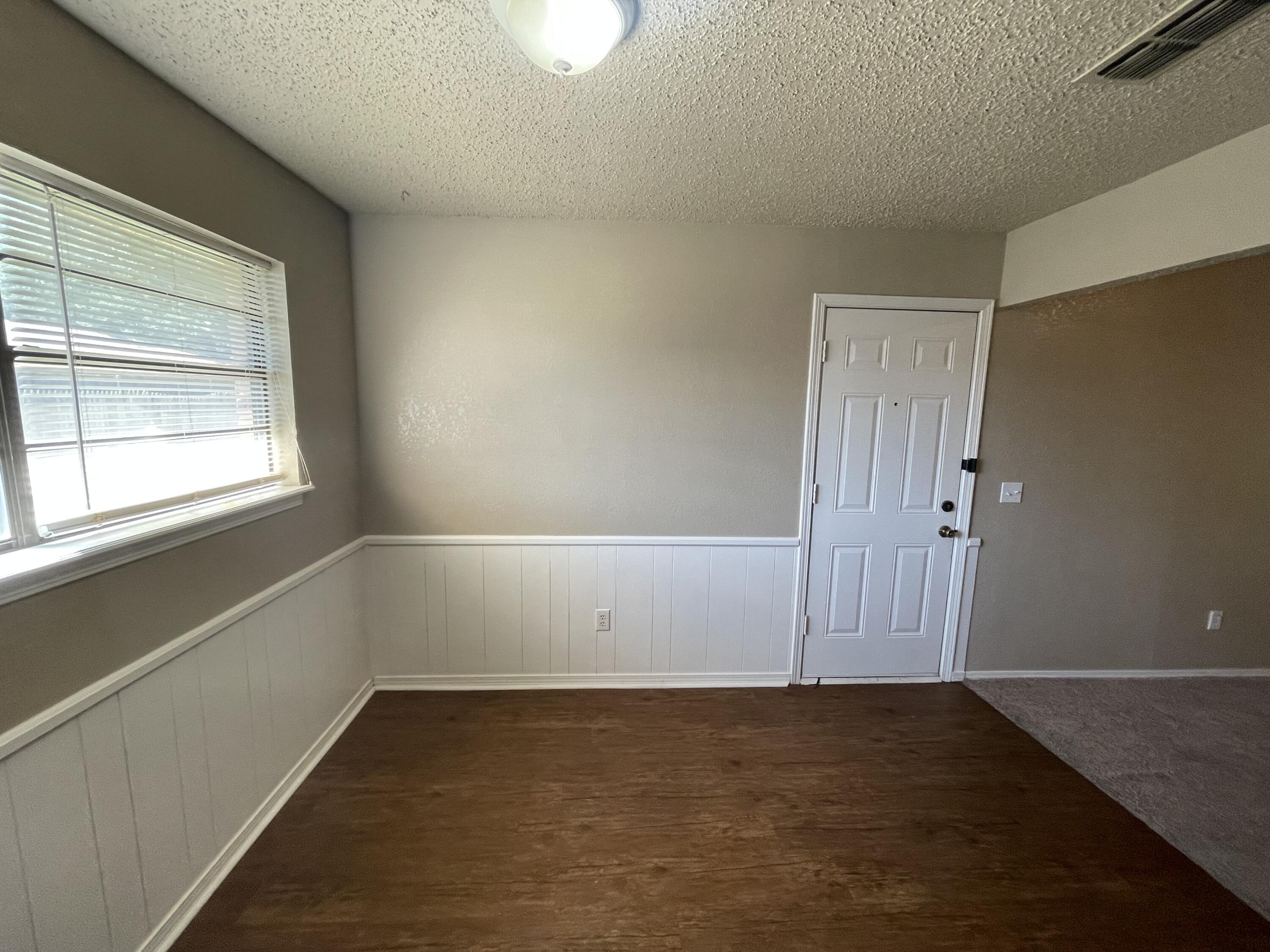 4413 75th Drive, Unit B Lubbock, TX 79424 - Photo 2 of 9 an empty room with a empty space and window