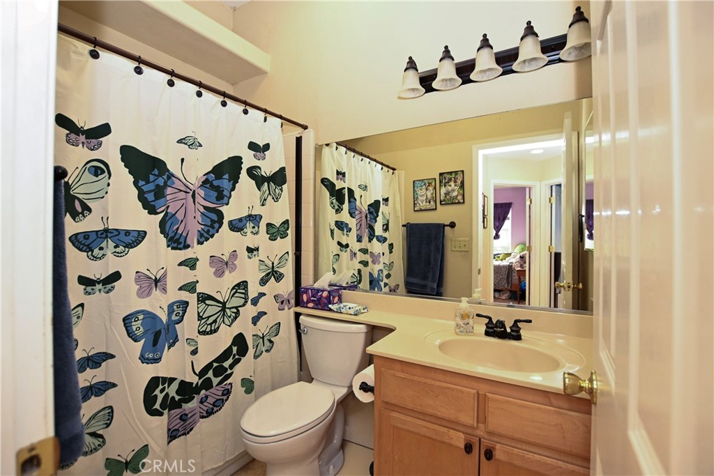 1422 Ridgebrook Way Chico, CA 95928 - Photo 11 of 25 a bathroom with a sink mirror vanity and toilet