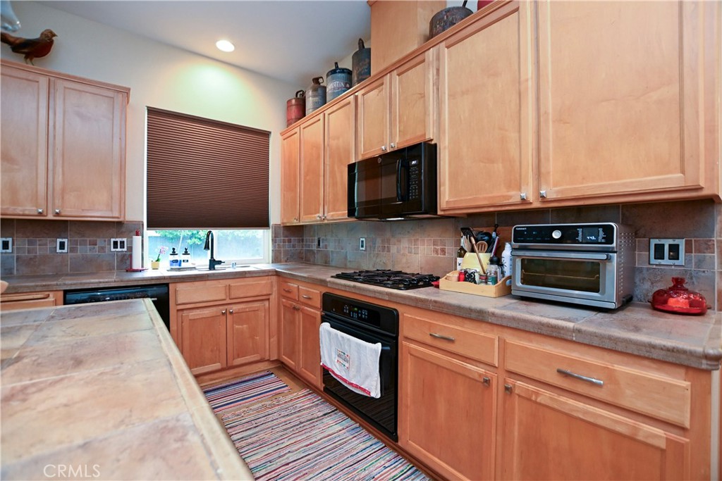1422 Ridgebrook Way Chico, CA 95928 - Photo 4 of 25 a kitchen with stainless steel appliances granite countertop a stove a sink and a microwave