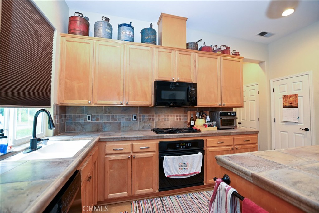 1422 Ridgebrook Way Chico, CA 95928 - Photo 5 of 25 a kitchen with a sink a stove and cabinets