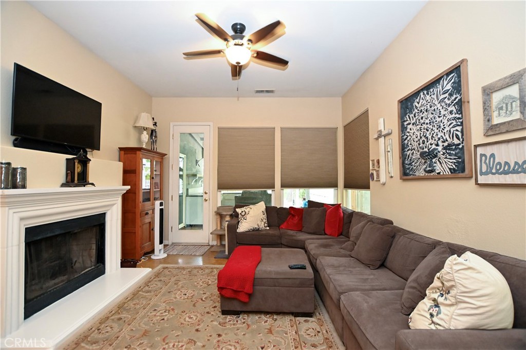 1422 Ridgebrook Way Chico, CA 95928 - Photo 7 of 25 a living room with furniture a flat screen tv and a fireplace