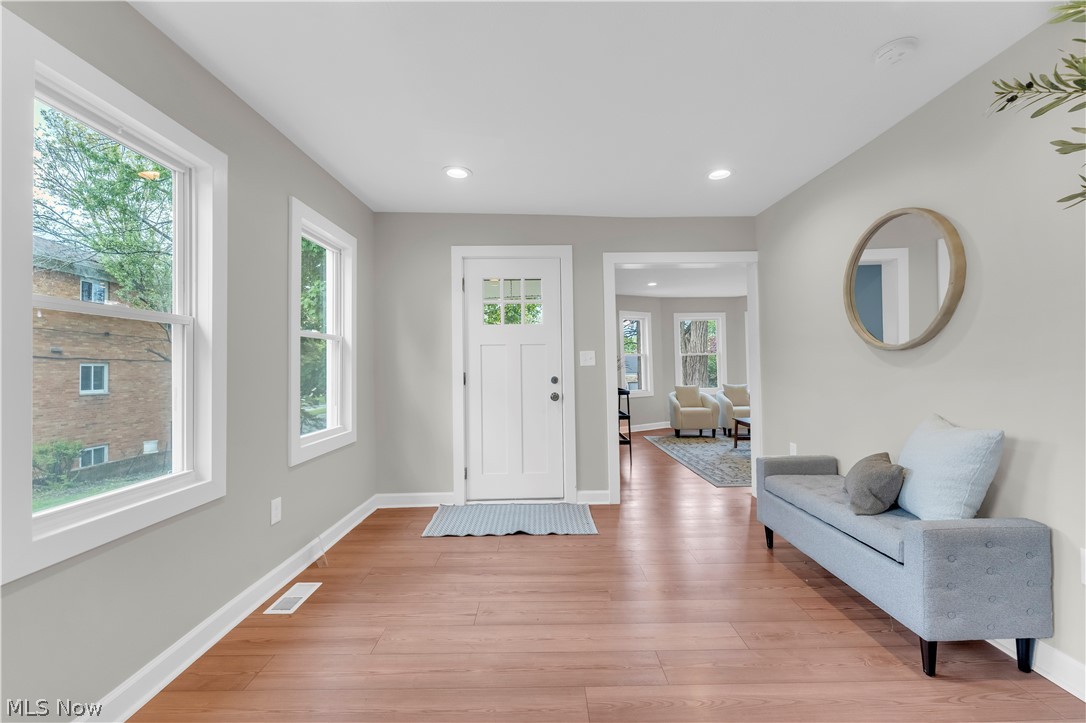 18155 Libby Road Maple Heights, OH 44137 - Photo 4 of 32 Entryway featuring wood-finish flooring, recessed lighting, and a white paneled door with glass inserts