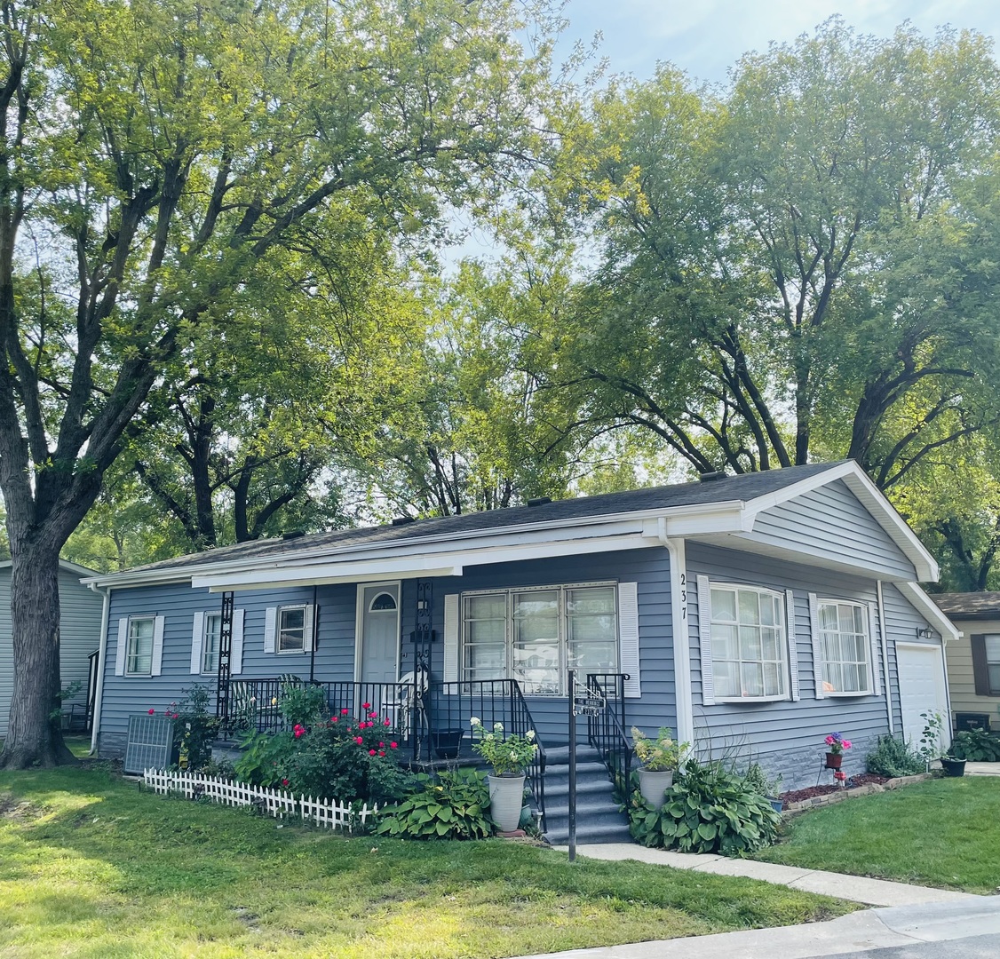 237 Parkwood Road Elgin, IL 60123 - Photo 1 of 15 a front view of a house with garden