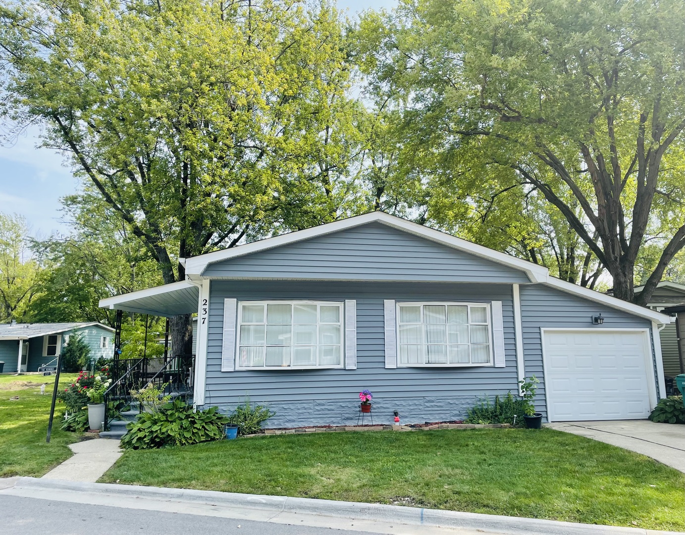 237 Parkwood Road Elgin, IL 60123 - Photo 2 of 15 a front view of a house with a garden and plants