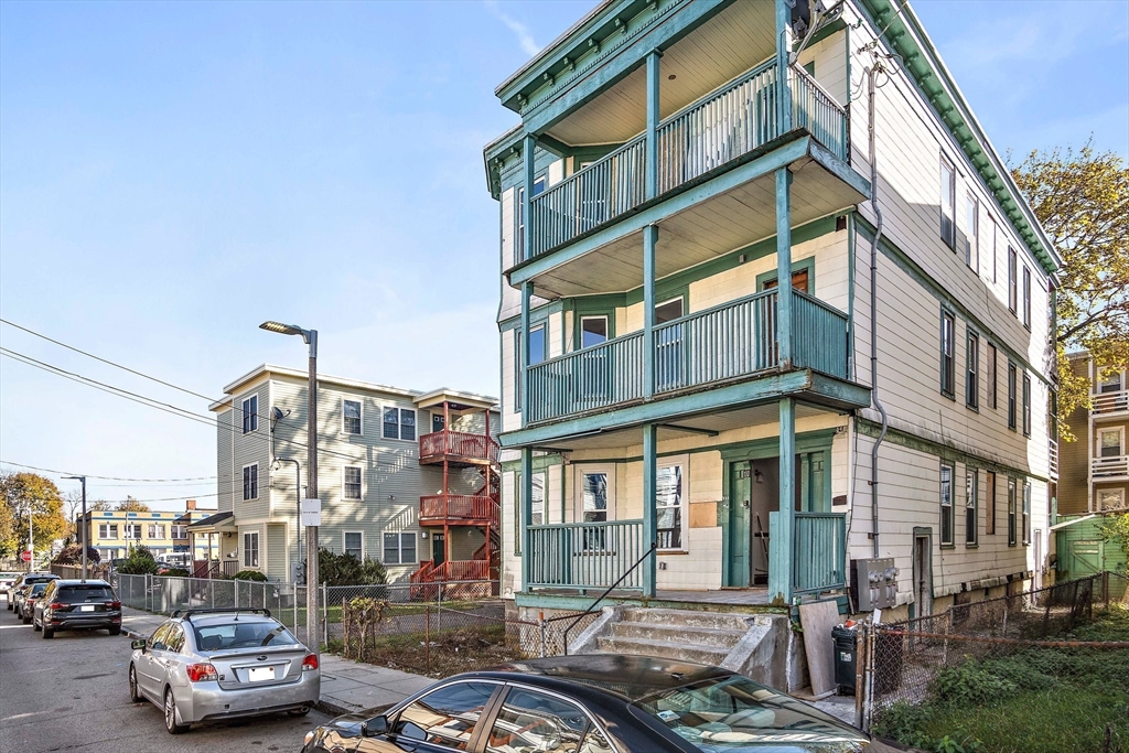 10 Sutton Street, Unit 3 Boston, MA 02126 - Photo 12 of 18 a city street lined with parked cars and buildings