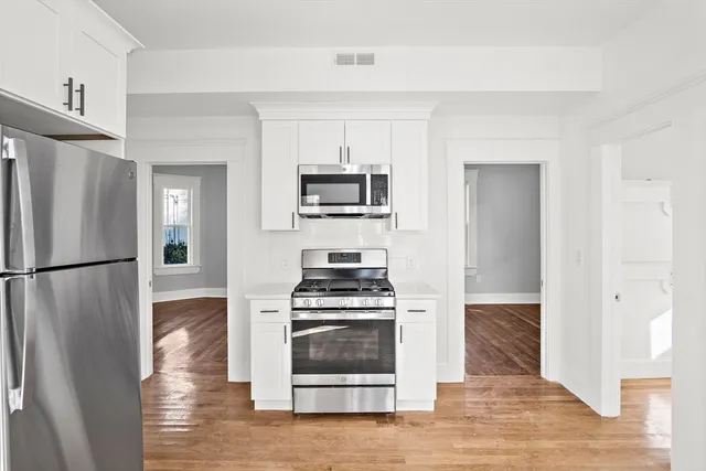 a kitchen with a stove and a refrigerator