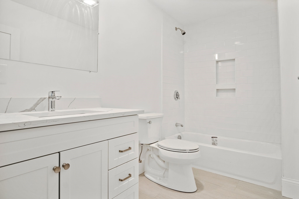 10 Sutton Street, Unit 3 Boston, MA 02126 - Photo 4 of 18 a bathroom with a sink toilet and shower