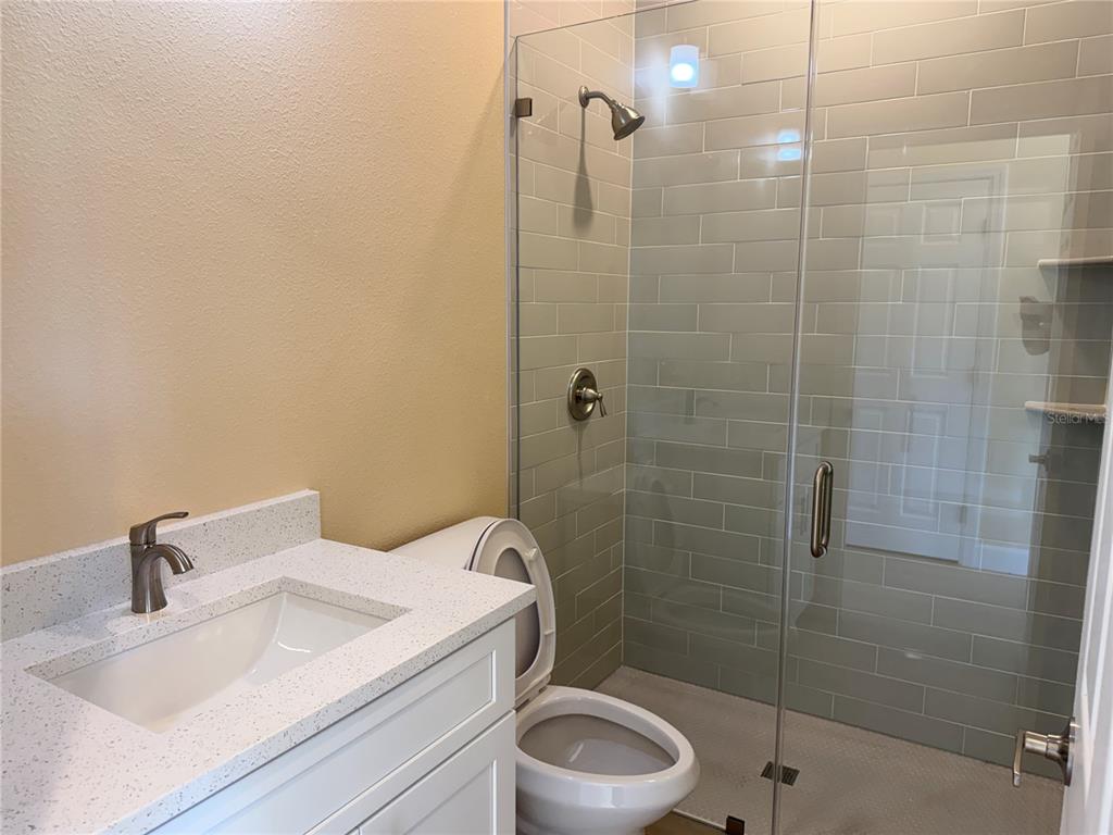 4661 Hickory Tree Road St. Cloud, FL 34772 - Photo 12 of 20 a bathroom with a sink a toilet and shower