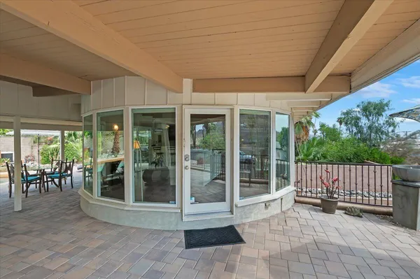 a view of a porch with wooden floor and outdoor seating