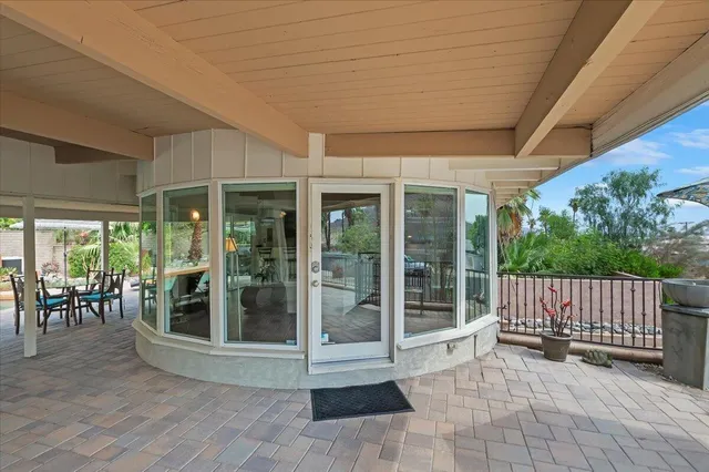 a view of a porch with wooden floor and outdoor seating