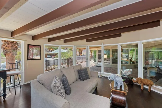 a living room with furniture and a floor to ceiling window