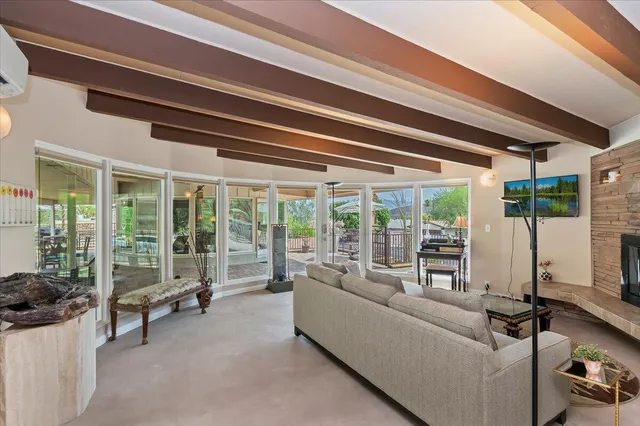 a living room with furniture and a floor to ceiling window