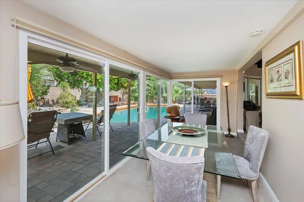 a dining room with furniture and wooden floor