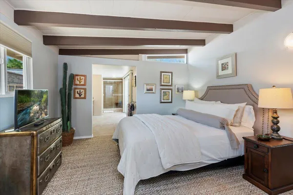 a bedroom with a bed and a table