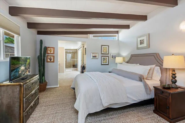 a bedroom with a bed and a table