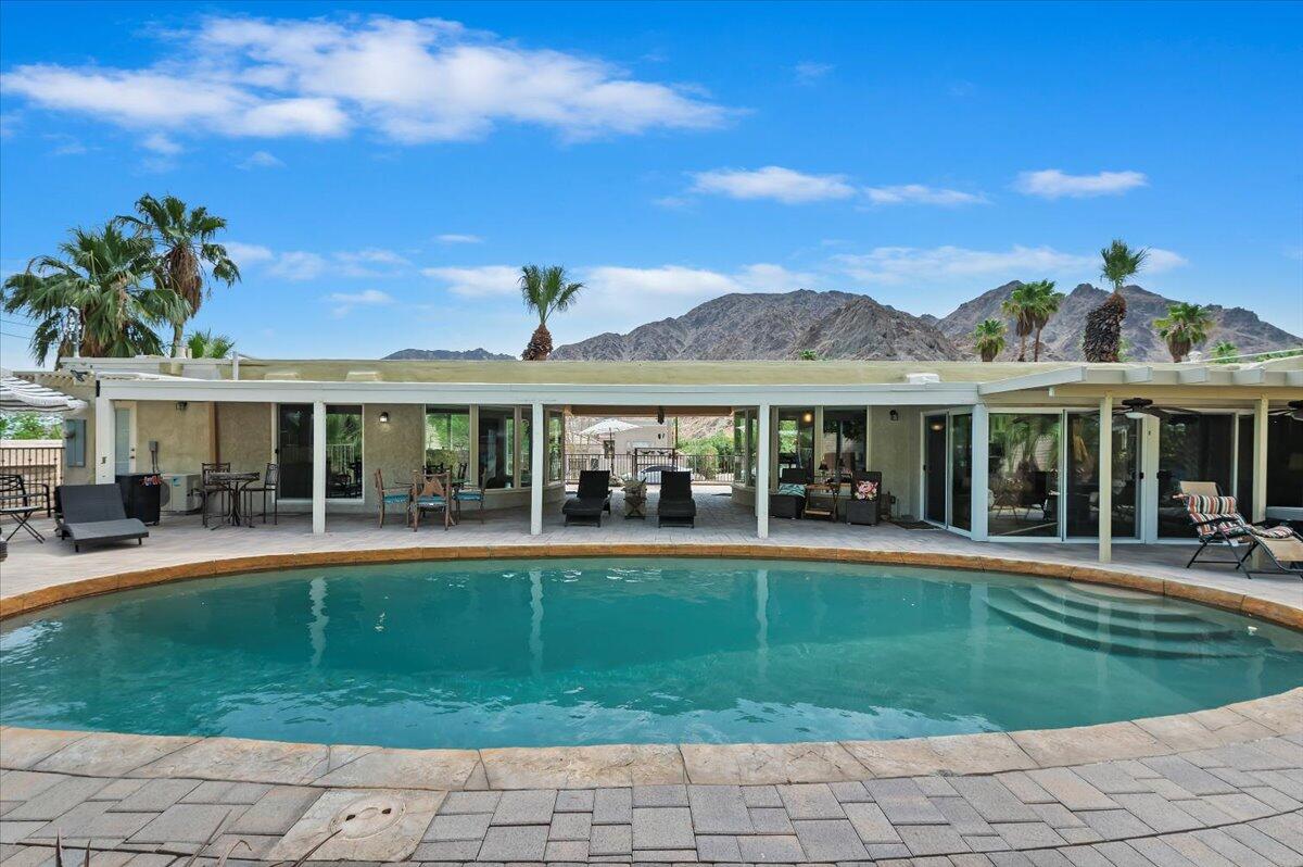 54925 Avenida Ramirez La Quinta, CA 92253 - Photo 40 of 50 a view of a house with swimming pool and a yard