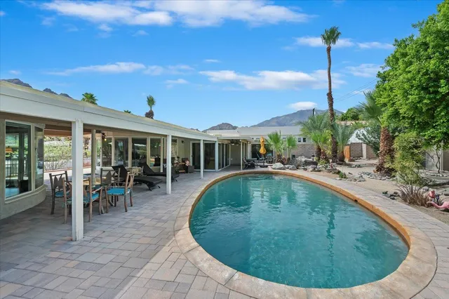 a front view of a house with swimming pool and porch
