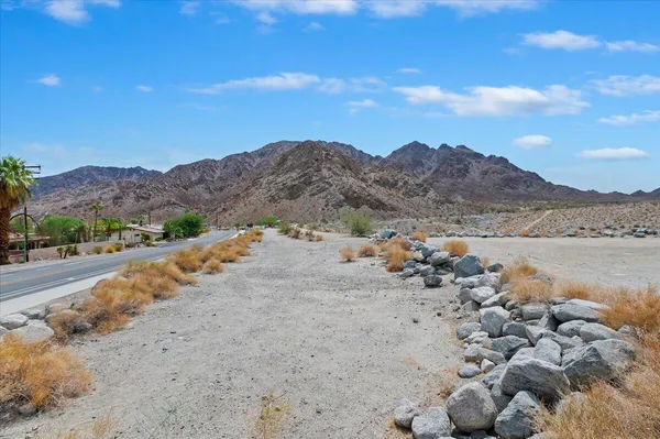 a view of a patio with table and chairs and potted plants