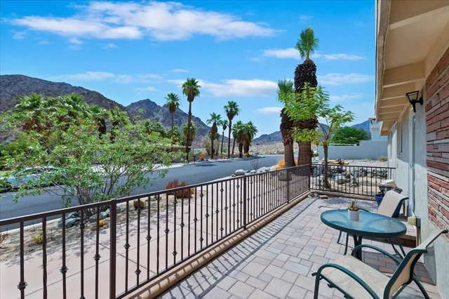 a view of a balcony with chairs