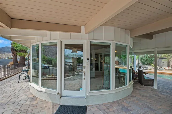 a view of a patio with table and chairs