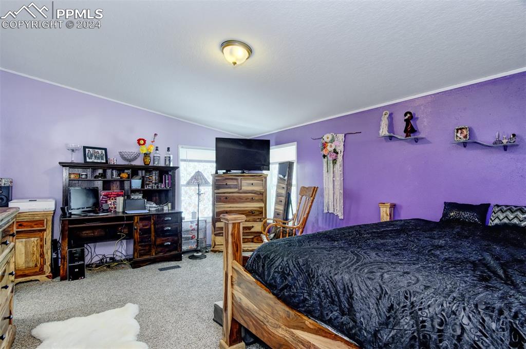 7270 South Yoder Road Yoder, CO 80864 - Photo 12 of 37 a bedroom with a bed and a book shelf