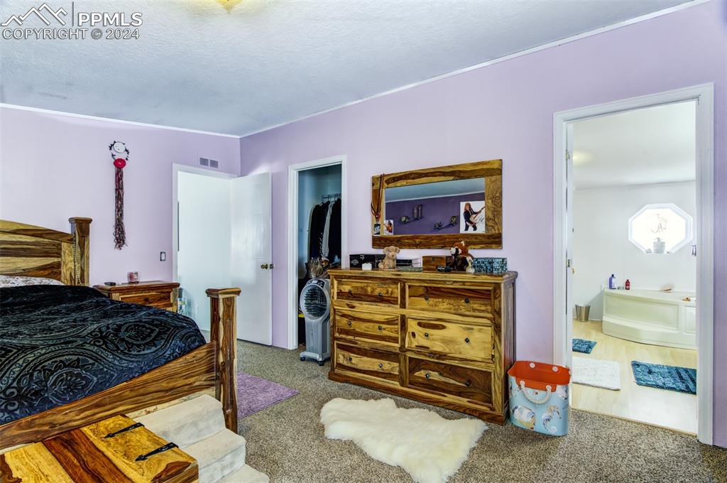 7270 South Yoder Road Yoder, CO 80864 - Photo 13 of 37 a bedroom with a bed and furniture