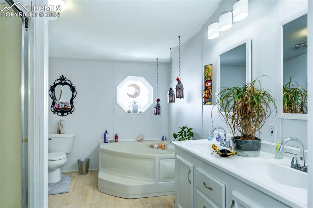 7270 South Yoder Road Yoder, CO 80864 - Photo 14 of 37 a bathroom with a sink a toilet and a mirror