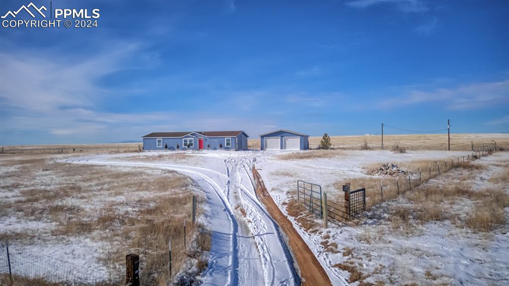 7270 South Yoder Road Yoder, CO 80864 - Photo 3 of 37 a bedroom with a bed and a night stand