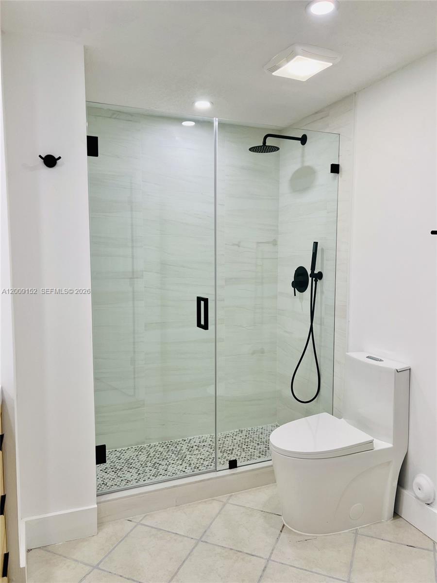 3500 Coral Way, Unit 1102 Miami, FL 33145 - Photo 2 of 8 a bathroom with a toilet sink and shower