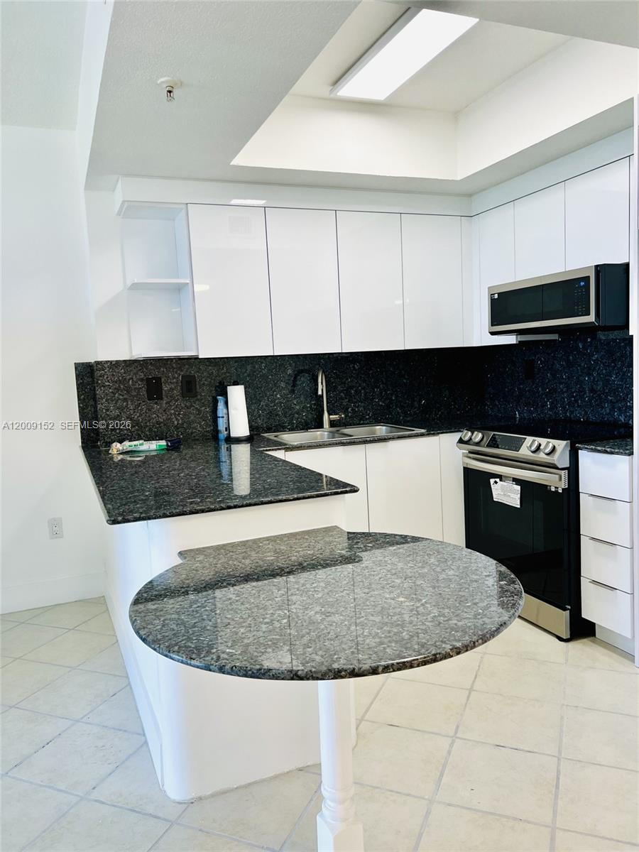 3500 Coral Way, Unit 1102 Miami, FL 33145 - Photo 8 of 8 a kitchen with a sink a stove and refrigerator